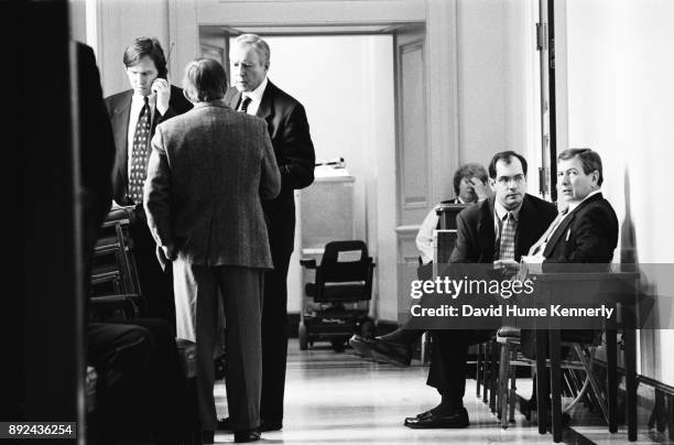 Republican senators Orrin Hatch, of Utah, and John Ashcroft of Missouri confer with aides during the Senate Impeachment Trial of President Bill...