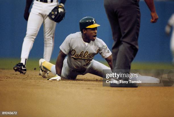 Outfielder Rickey Henderson of the Oakland A's steals secondbase during a game in September, 1990 against the Cleveland Indians at Cleveland...