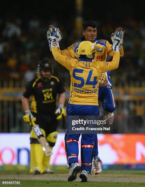 Mujeeb Zadran and Sarfraz Ahmed of Bengal Tigers celebrates the wicket of Eoin Morgan of Kerela Kingsduring the T10 League match between Bengal...
