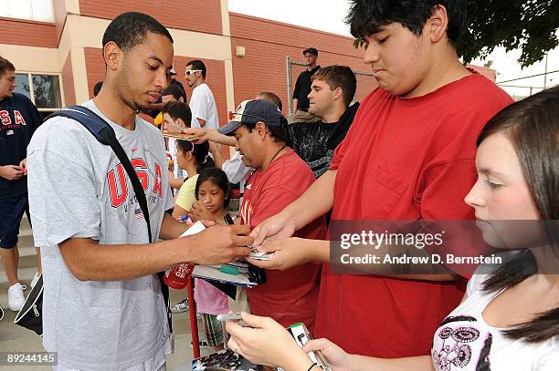 Devin Harris of the USA Men's National Basketball Team signing autographs after practice during mini-camp on July 24, 2009 at Valley High School in...