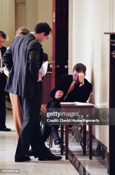 Republican Sen. John Ashcroft reads some papers in the hallway of the U.S. Capitol Building during the Senate Impeachment Trial of President Bill...