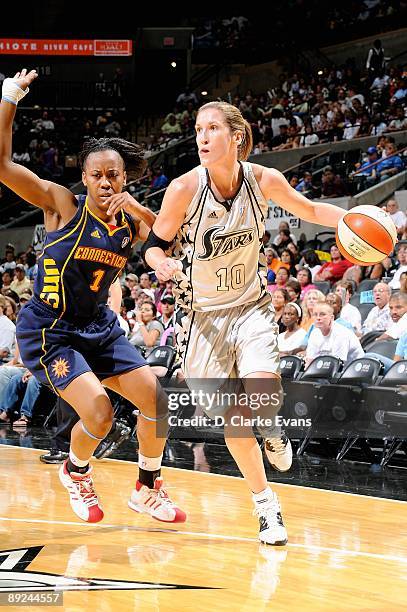Belinda Snell of the San Antonio Silver Stars drives to the basket past Amber Holt of the Connecticut Sun during the WNBA game on July 17, 2009 at...
