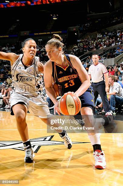 Lindsay Whalen of the Connecticut Sun drives to the basket past Helen Darling of the San Antonio Silver Stars during the WNBA game on July 17, 2009...