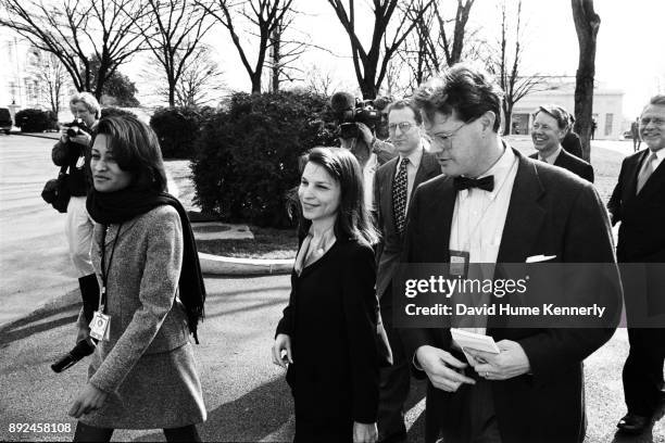 Journalists talks with lawyers for President Bill Clinton, including Cheryl Mills, Nicole Seligman, Lanny Breuer, and David Kendall, as they walk to...