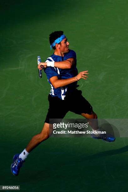 Wayne Odesnik returns a shot to John Isner during the Indianapolis Tennis Championships on July 24, 2009 at the Indianapolis Tennis Center in...