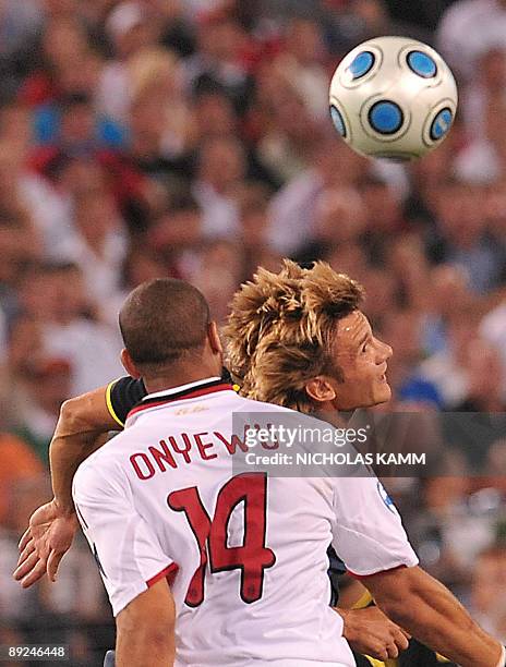 Chelsea's Andriy Shevchenko heads the ball in front of AC Milan's Oguchi Onyewu during a World Football Challenge match at B&T Bank Stadium in...