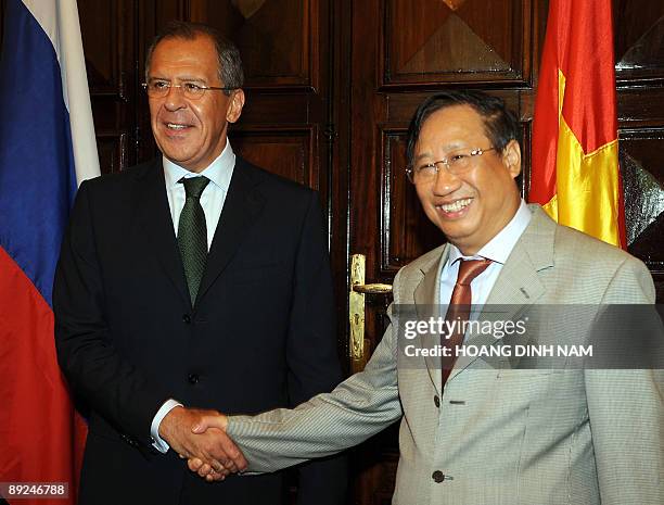 Visiting Russian Foreign Minister Sergei Lavrov shakes hands with Vietnamese Deputy Prime Minister and Minister of Foreign Affairs Pham Gia Khiem as...