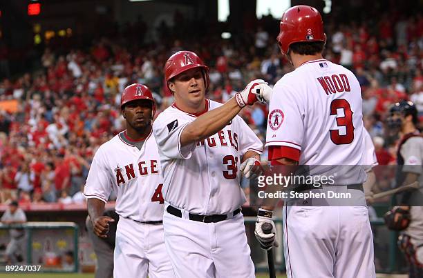 Robb Quinlan of the Los Angeles Angels of Anaheim is greeted by Brandon Wood after Quinlan and Howie Kendrick scored on Quinlan's two-run home run in...