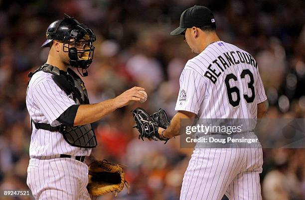 Catcher Chris Iannetta of the Colorado Rockies gives the ball to relief pitcher Rafael Betancourt as he makes his debut with the Rockies and faces...