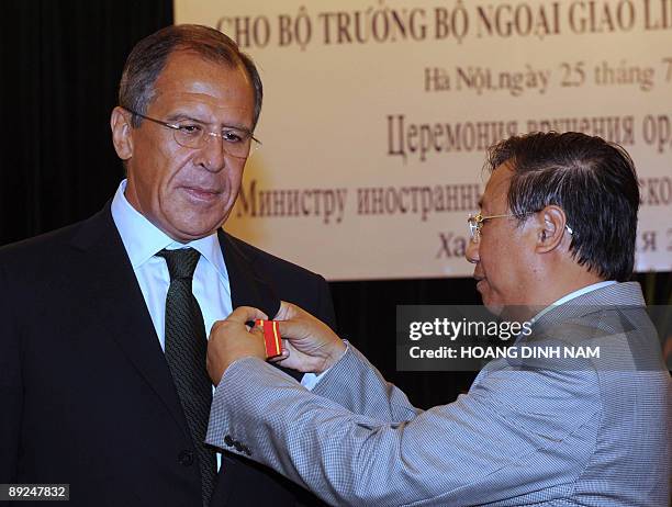 Vietnamese deputy Prime Minister and Minister of Foreign Affairs Pham Gia Khiem pins a Friendship Medal onto visiting Russian Foreign Minister Sergei...