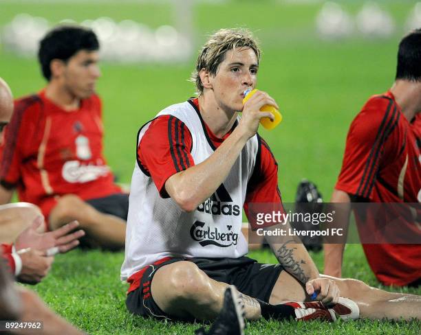 Fernando Torres of Liverpool drinks a sports drink during a training session for their pre-season Far East tour at Singapore National Stadium on July...