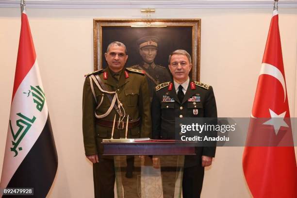 Chief of the General Staff of the Turkish Armed Forces Hulusi Akar and Iraqi Army Chief of Staff Othman al-Ghanimi pose for a photo during their...