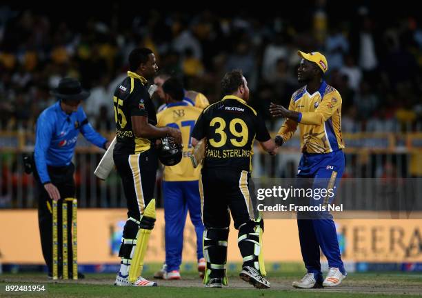 Players shake hands after the T10 League match between Bengal Tigers and Kerala Kings at Sharjah Cricket Stadium on December 14, 2017 in Sharjah,...