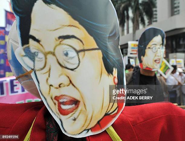 Indonesian students hold up mannequins bearing the face of ex-president and opposition leader Megawati Sukarnoputri during a rally to support the...
