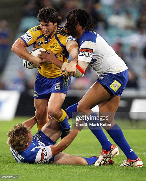 Nathan Hindmarsh of the Eels is tackled during the round 20 NRL match between the Bulldogs and the Parramatta Eels at ANZ Stadium on July 25, 2009 in...