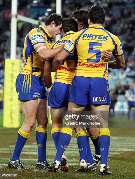 Kevin Kingston of the Eels is congratulated by his team mates after scoring a try during the round 20 NRL match between the Bulldogs and the...