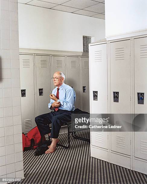mature man getting dressed in locker room - locker room bildbanksfoton och bilder