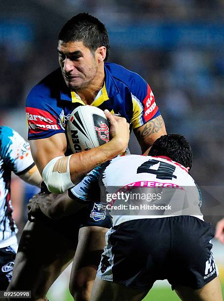 James Tamou of the Cowboys is tackled by Brad Tighe of the Panthers during the round 20 NRL match between the North Queensland Cowboys and the...