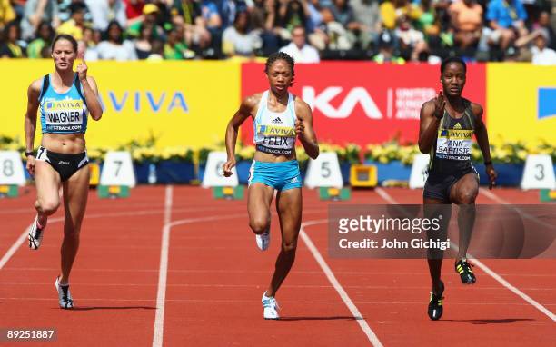 Allyson Felix of USA competes with Kelly Ann Baptiste of Trinidad & Tobago and Marion Wagner of Germany in the Women's 100 Metres heat 1 during day...