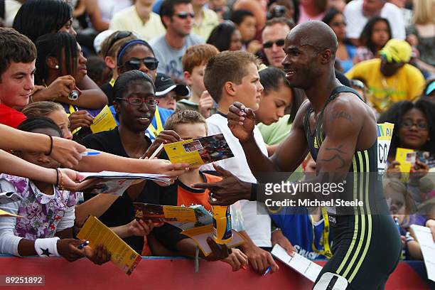 200m Sprinter Kim Collins of St. Kitts and Nevis signs autographs for the fans following his race during day two of the Aviva London Grand Prix track...