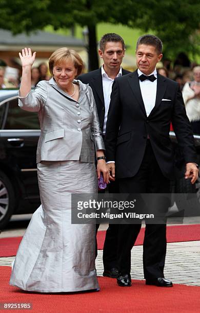 German Chancellor Angela Merkel and her husband Joachim Sauer arrive for the 'Tristan and Isolde' premiere of the Richard Wagner festival on July 25,...
