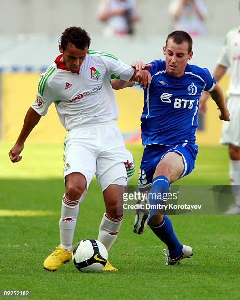 Charles of FC Lokomotiv Moscow battles for the ball with Luke Wilkshire of FC Dynamo Moscow during the Russian Football League Championship match...