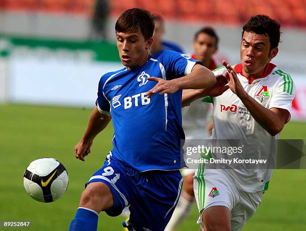 Rodolfo of FC Lokomotiv Moscow battles for the ball with Viktor Svezhov of FC Dynamo Moscow during the Russian Football League Championship match...