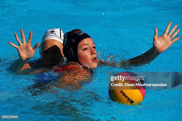 Iefke Van Belkum of Netherlands is closed down by Amy Logan of New Zealand as they compete in the Women's Water Polo Quarterfinal Qualification...