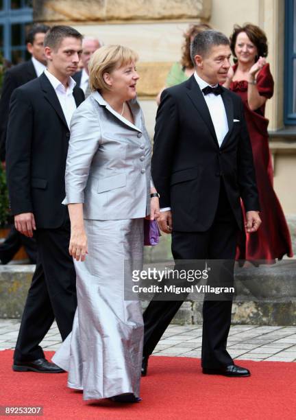 German Chancellor Angela Merkel and her husband Joachim Sauer arrive for the 'Tristan and Isolde' premiere of the Richard Wagner festival on July 25,...