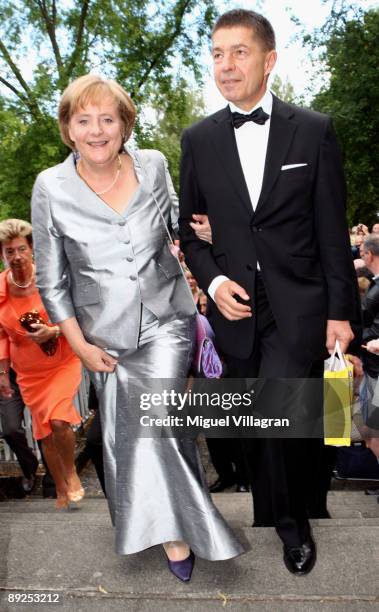 German Chancellor Angela Merkel and her husband Joachim Sauer are pictured during the first pause at the 'Tristan and Isolde' premiere of the Richard...