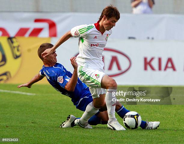Diniyar Bilyaletdinov of FC Lokomotiv Moscow battles for the ball with Marcin Kowalczyk of FC Dynamo Moscow during the Russian Football League...