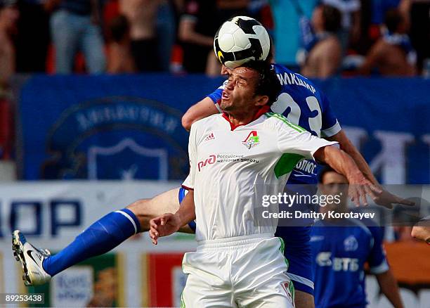 Charles of FC Lokomotiv Moscow battles for the ball with Luke Wilkshire of FC Dynamo Moscow during the Russian Football League Championship match...