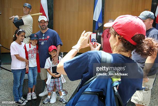 Fans pose for a photograph at the National Baseball Hall of Fame during induction weekend on July 25, 2009 in Cooperstown, New York.