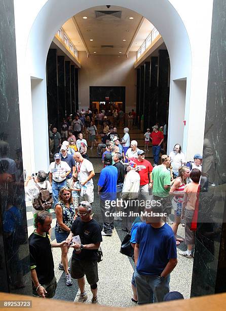 Baseball fans walk through the National Baseball Hall of Fame during induction weekend on July 25, 2009 in Cooperstown, New York.