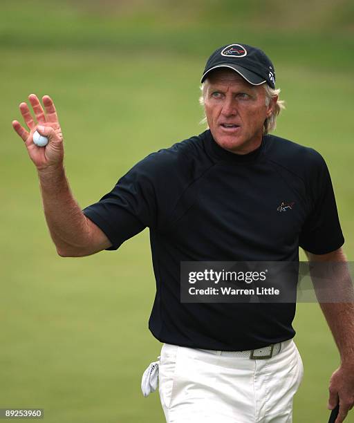 Greg Norman of Australia acknowledges the crowd on the 18th green during the third round of The Senior Open Championship presented by MasterCard held...