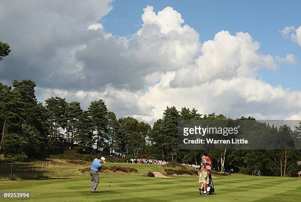Toim Watson of the USA plays his second shot into the 12th green during the third round of The Senior Open Championship presented by MasterCard held...