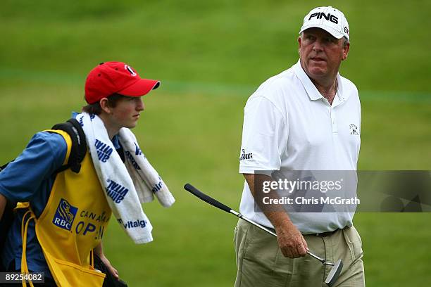 Mark Calcavecchia checks the leader board as he walks to the ninth green during round two of the RBC Canadian Open at Glen Abbey Golf Club on July...
