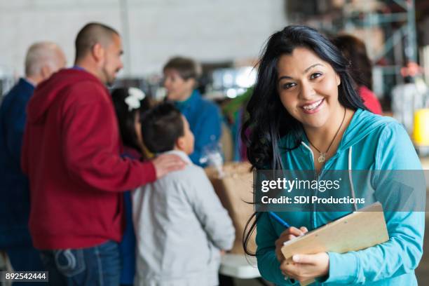 cheerful food drive manager - community outreach stock pictures, royalty-free photos & images