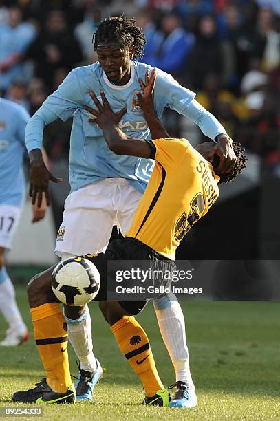 Emanuel Adebayor of Manchester City is tackled by Thomas Sweswe of Kaiser Chiefs during the final of the 2009 Vodacom Challenge match between Kaizer...