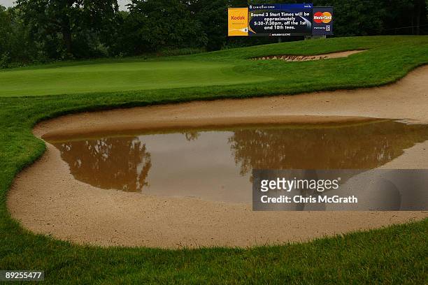 Pool of water gathers in a 16th green bunker after round two of the RBC Canadian Open at Glen Abbey Golf Club on July 25, 2009 in Oakville, Ontario,...