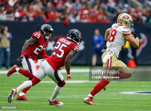 Garrett Celek of the San Francisco 49ers runs with the ball after a pass as Kareem Jackson of the Houston Texans and Andre Hal pursue at NRG Stadium...