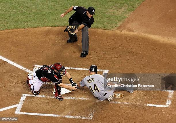 Catcher Miguel Montero of the Arizona Diamondbacks tags out the sliding Brandon Moss of the Pittsburgh Pirates as he attempts to score during the...