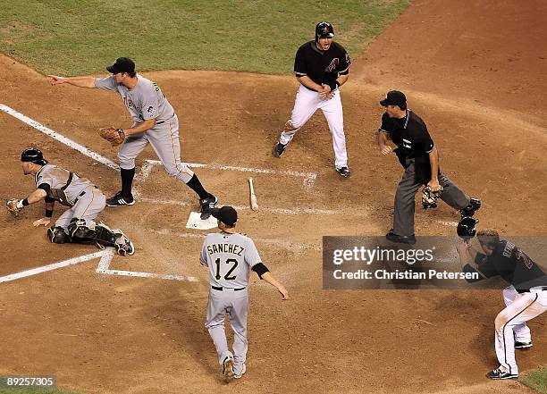 Miguel Montero and Mark Reynolds of the Arizona Diamondbacks react as umpire James Hoye calls Montero out after he was taged by catcher Ryan Doumit...