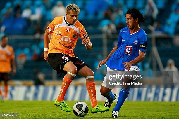 Cristian Riveros of Cruz Azul vies for the ball with Adolfo Bautista of Jaguares during their match valid for the2009 Opening tournament of the...