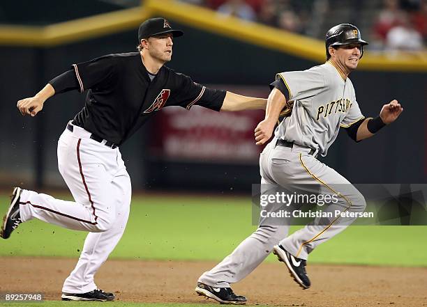 Infielder Mark Reynolds of the Arizona Diamondbacks tags out Andy LaRoche of the Pittsburgh Pirates during a run down in the major league baseball...