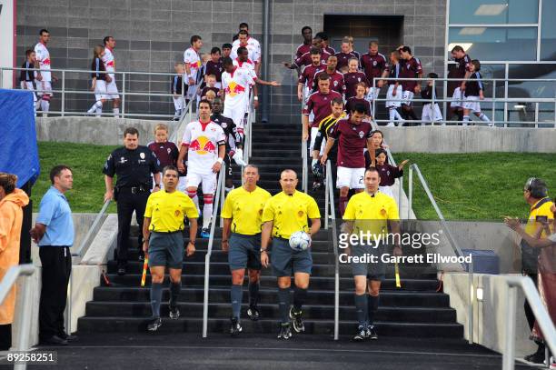 The officials lead the teams out prior to the game between the New York Red Bulls and the Colorado Rapids on July 25, 2009 at Dicks Sporting Goods...