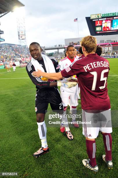 Bouna Coundoul of the New York Red Bulls shakes hands with Jacob Peterson of the Colorado Rapids prior to the game on July 25, 2009 at Dicks Sporting...