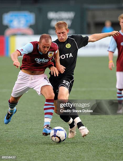 Steven Fletcher of Burnley battles for the ball against Keith Savage of the Portland Timbers during the first half of the match at PGE Park on July...