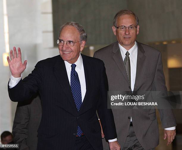 Middle East envoy George Mitchell waves upon his arrival with his advisor Frederick Hoff at al-Shaab palace in Damascus for a meeting with Syrian...