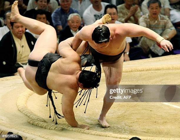 Grand champion Hakuho throws fellow Mongolian grand champion Asashoryu in the last day of the Nagoya Grand Sumo Tournament at Aichi Prefectural...